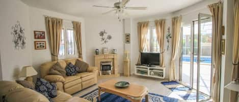 Family Room (Lounge) with double patio doors leading to the terrace and pool.