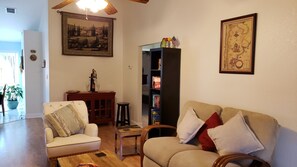 Comfortable living room with 2 couches and an armchair can sit 5 people.