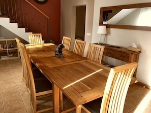 Big Dining Table seats everyone. Shows stairs to Bedroom 1 and Lounge entrance.