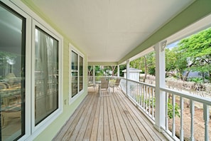 Wrap-around porch with table and chairs to enjoy coffee, meals or cocktails