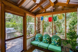 The empty tin sheds lining the cabin property give character to the place.  Enjoy this screened outdoor space on a lazy afternoon.