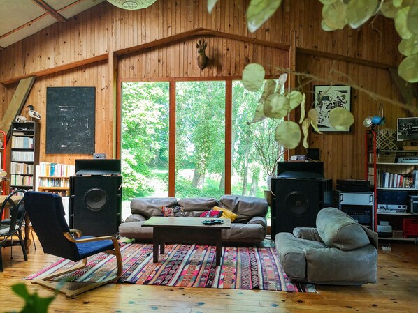 Salon avec vue sur la nature et enceinte de haute fidélité 