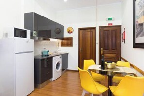 There's a dining table next to the kitchen that enables you to eat with your friends and family.