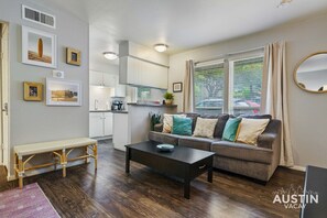 Living area with sleeper sofa and coffee table that flips up so you can work or eat here