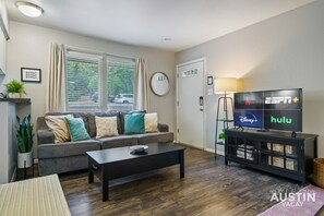 Living area with sleeper sofa and coffee table that flips up so you can work or eat here