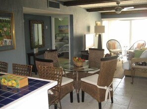 Dining table for four, plus counter with three bar stools.