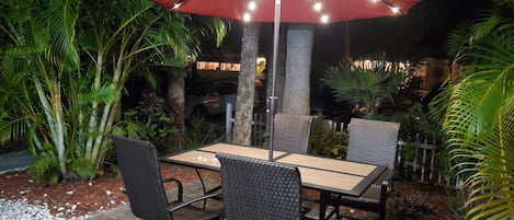 New Umbrella on the Front Patio with solar-powered LED lighting!