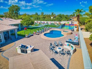 [Backyard] Outdoor gas grill, gas fire pit, dining and lounge space next to the heated pool, hot tub, splash pad, play yard