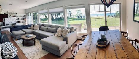 Panoramic photo of the dining and living room areas with great views of the lake