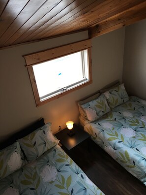 upper level bedroom with a queen and a double and a loft for the kids