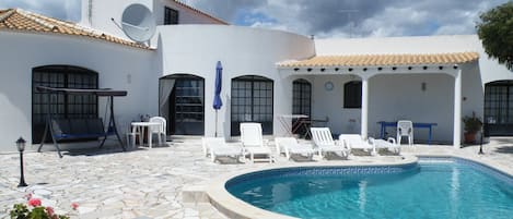 Dine al fresco beside the tear-drop shaped pool.