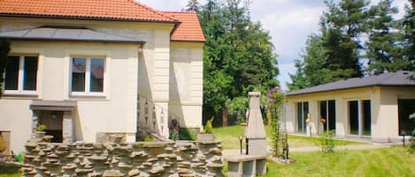 The house and swimming pool in the left separate building