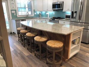 View of the kitchen island which is backed with wood from the original house