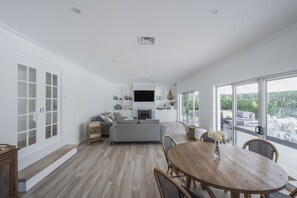 Sunken Lounge room with fireplace, smart TV with Foxtel and casual dining