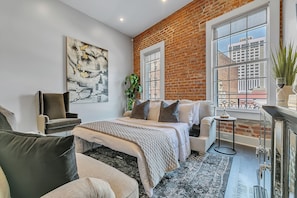 Open-concept living, kitchen, dining area with ample seating for you and your guests. 65” Samsung Smart 4K TV with streaming and DIRECTV Entertainment. The sofa converts to a queen-size sleeper! Dining table seats two. Enjoy plenty of natural light!