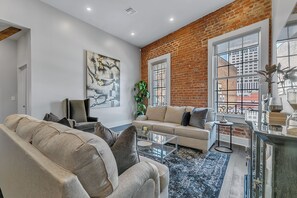 Open-concept living, kitchen, dining area with ample seating for you and your guests. 65” Samsung Smart 4K TV with streaming and DIRECTV Entertainment. The sofa converts to a queen-size sleeper! Dining table seats two. Enjoy plenty of natural light!