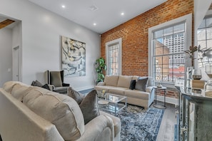 Open-concept living, kitchen, dining area with ample seating for you and your guests. 65” Samsung Smart 4K TV with streaming and DIRECTV Entertainment. The sofa converts to a queen-size sleeper! Dining table seats two. Enjoy plenty of natural light!
