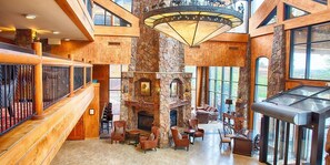 Entry way that has large Christmas tree during season.