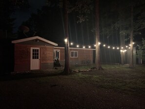 Front of cabin lit at night