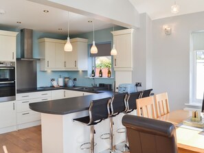 Well appointed kitchen with breakfast bar | Grays Cottage, Bridlington