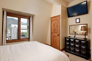 The second bedroom has a queen bed and a flat screen TV.