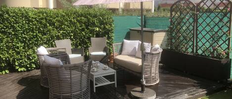 Comfortable deck seating and sun umbrella.