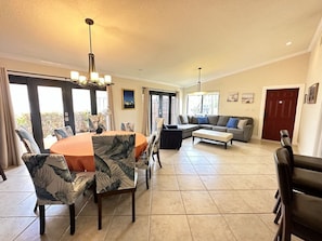 Living room area with plenty of comfortable seating and dining table