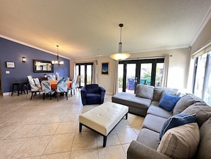 Living room area with plenty of comfortable seating and dining table