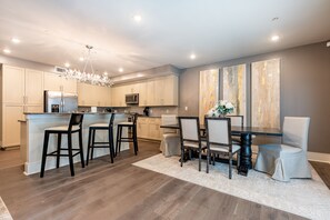 Cook and dine easily in the fully stocked kitchen, equipped with all stainless steel appliances, gas range, basic cookware, and a dining area for a comfortable meal at home. Entertain at the island with seating for three.