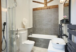 En-suite bathroom to bedroom one with bath and separate shower
