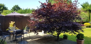 Private patio with seating for four and two sun loungers to enjoy 