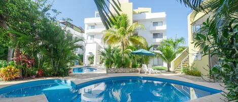 The ATSI community swimming pool complete with lounge chairs and Umbrellas.