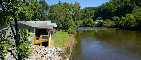 Exterior View - View of back of home and river right behind cabin.