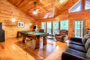 Lofted game room with pool table and arcades