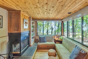 Cozy up by the fireplace in the Den