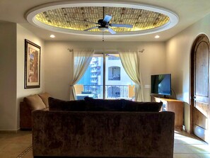 Living room with brick ceiling dome, dimming LEDs, new TV, and new ceiling fan