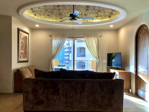 Living room with brick ceiling dome, dimming LEDs, new TV, and new ceiling fan