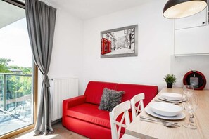 Living room with a kitchenette and exit to balcony