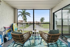 This nicely appointed screened in lanai is a great place to share a meal or relax with a drink after a fun day in the sun around one of the two pools.