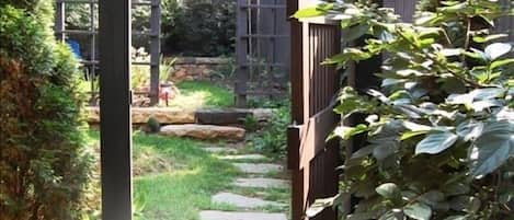 A stone path winding through the Studio's garden leads to its private entrance.