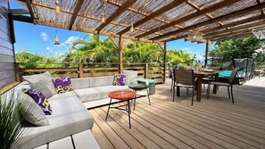 Large covered terrace with lounge area and dining table