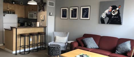 Living room with view of bar seating and kitchen