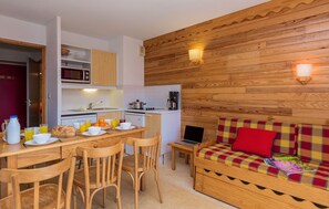Prepare meals in the kitchenette and enjoy them at the dining table.
