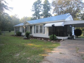 Front of the house with a carport