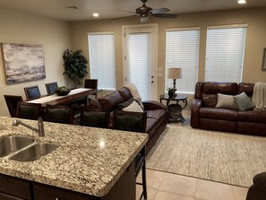 Full-sized kitchen with a granite top island that opens to the gathering area.