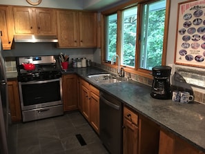 Newly redone kitchen with granite counters and stainless appliances.  