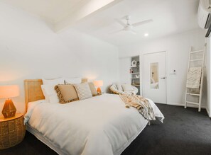 Master bedroom with spilt system cooling and heating, ceiling fan, smart TV, walk in wardrobe and ensuite bathroom