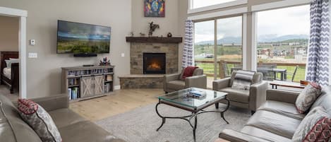 Living room with smart tv, fireplace and views of the Continental Divide.