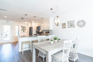 Dining area with additional seating at the counter and outdoor patio. 