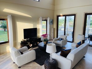 Living room opens up to covered balcony